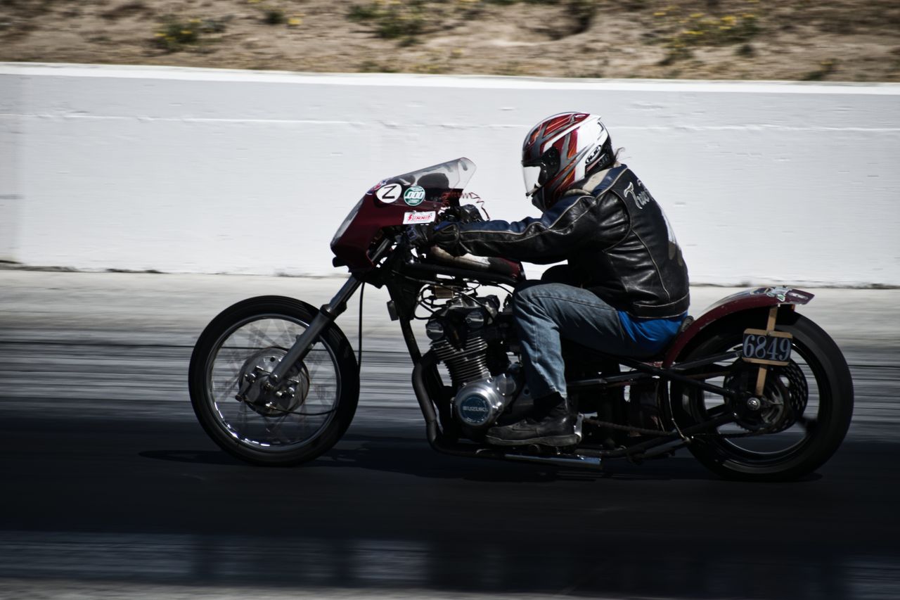 Motorcyclist racing at high speed on a smooth track, showcasing skill and precision.